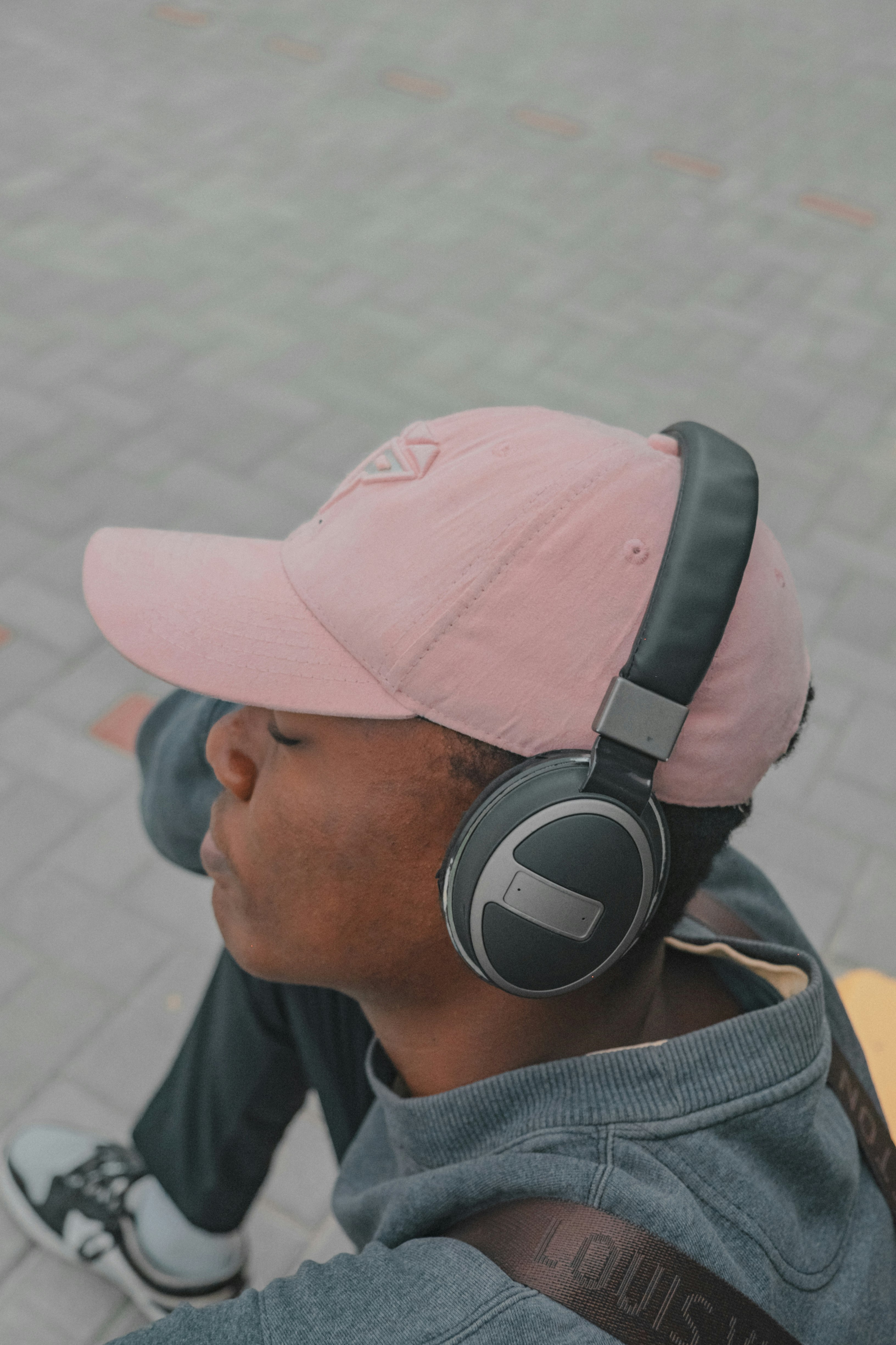 man in pink cap and black headphones